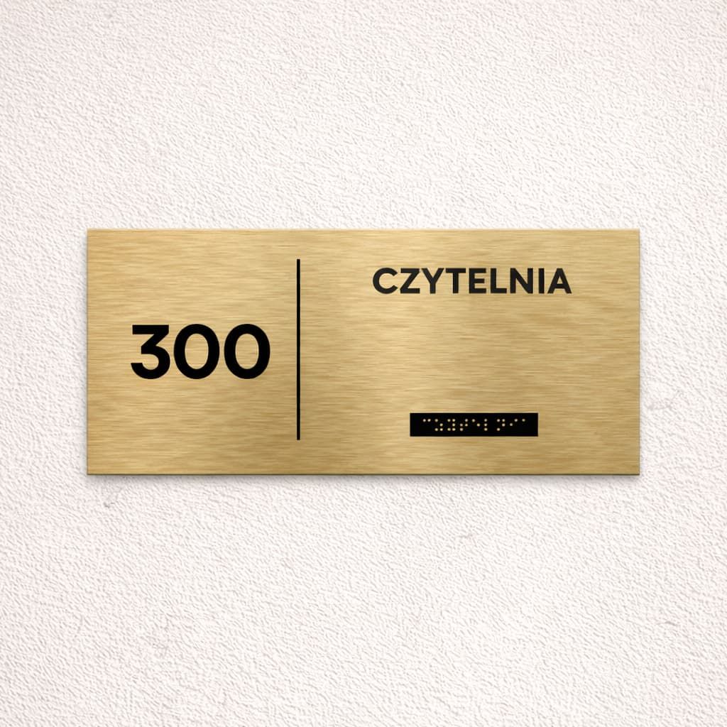 Tabliczka Braille z nazwą pomieszczenia, tekstem i piktogramem na jednej powierzchni