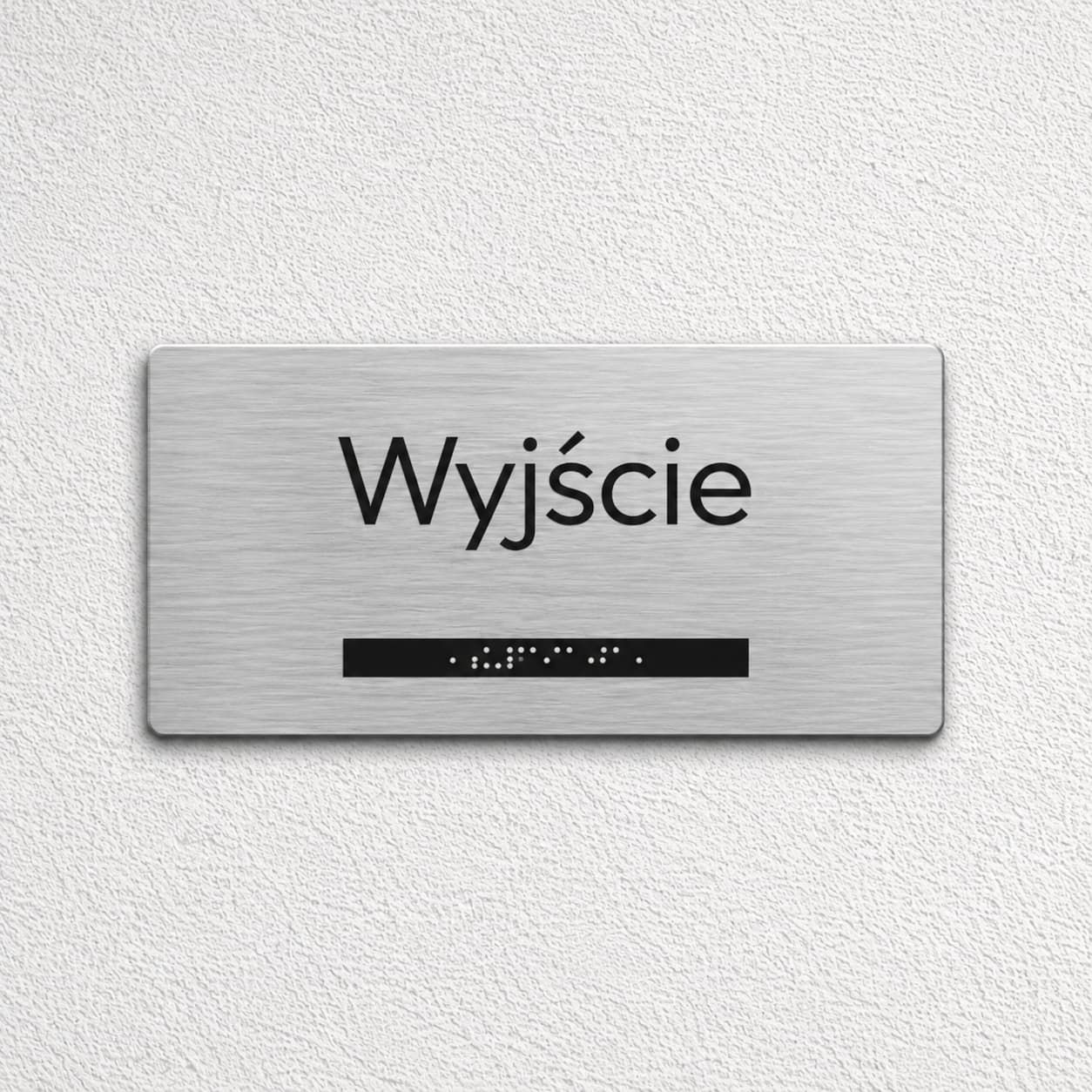 Srebrna tabliczka Braille z napisem Wyjście i strzałką