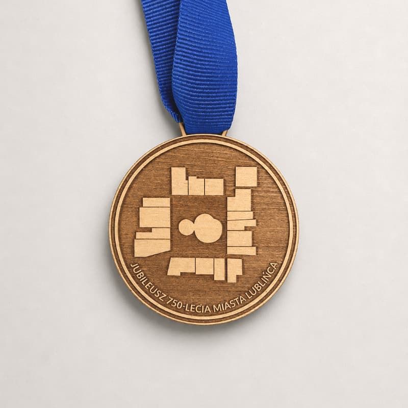 Drewniany medal z niebieską tasiemką i grawerem laserowym